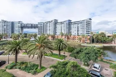 a view of a city with palm trees and buildings at Ezey Tours-Manhattan Suites in Cape Town