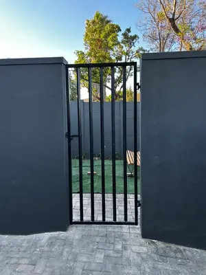an open gate with a view of a yard at Alicante in Worcester
