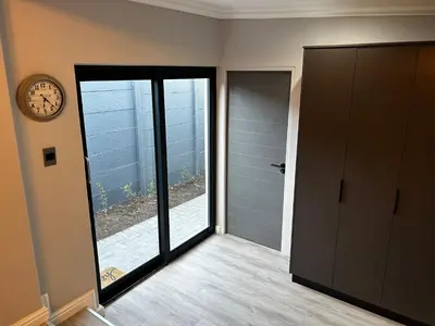 a room with a clock and a door with a window at Alicante in Worcester