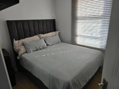 a large bed in a room with a window at Secure 2 Bedroom Ground Floor Apartment in Joostenberg Vlakte