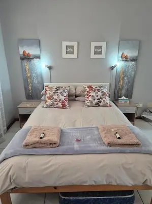 a bedroom with a bed with two towels on it at Sune's self catering 2 in Worcester