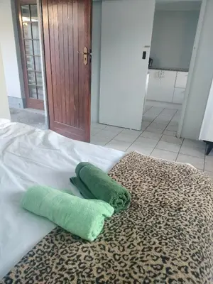 two green towels sitting on top of a bed at Near Grandwest in Thornton