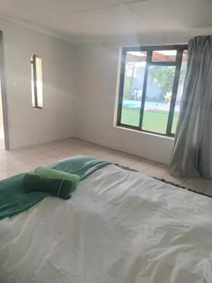 a large bed in a room with a window at Near Grandwest in Thornton