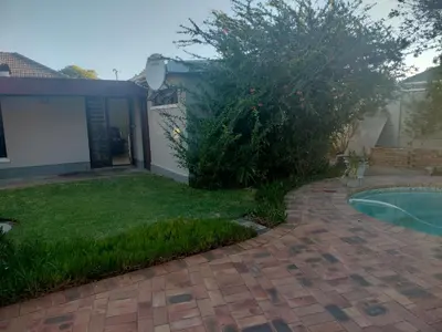 a yard with a brick walkway next to a swimming pool at Near Grandwest in Thornton