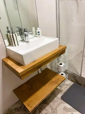 a bathroom with a white sink and a mirror at Bachelors Unit at The Den in Stellenbosch