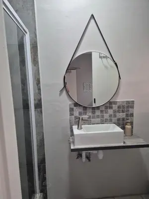 a bathroom with a sink and a mirror at Suné's Self Catering 1 in Worcester