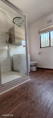 an empty room with a toilet and a glass door at Pet Friendly Sandbaai in Hermanus