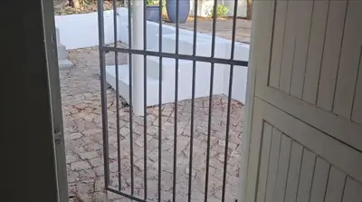 a gate in front of a door with a porch at Escape Root in Caledon