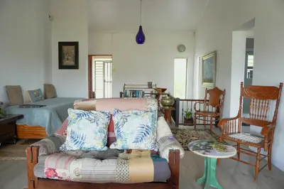 a living room with a couch and a bed at Leah's View in Pringle Bay