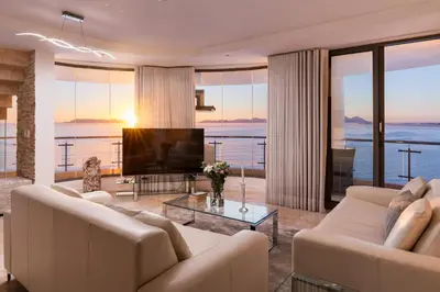 a living room with a couch and a television at Main Hibernian Penthouse in Strand