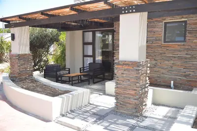 an outdoor patio with a wooden pergola at Misasa on Orchard in Cape Town