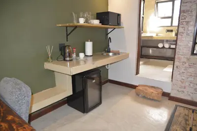 a room with a desk and a sink in a room at Misasa on Orchard in Cape Town