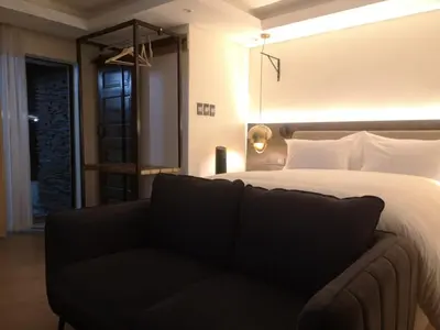a bedroom with a bed and a couch at Misasa on Orchard in Cape Town