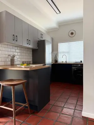 a kitchen with a counter and a stool in it at Die Stal in Wellington