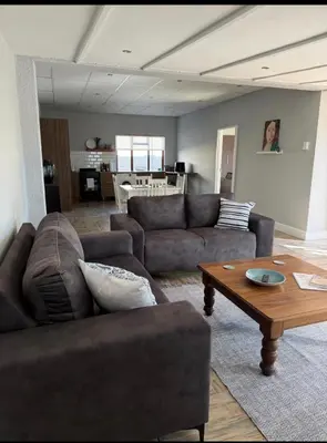 a living room with two couches and a coffee table at Fijnbos in Strand