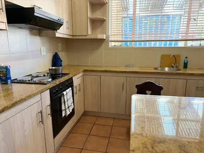 a kitchen with a stove and a sink at Home of peace self catering accommodation