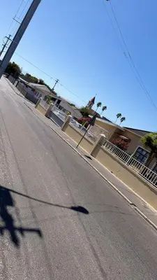 a shadow of a person riding a skateboard down a street at Home of peace self catering accommodation