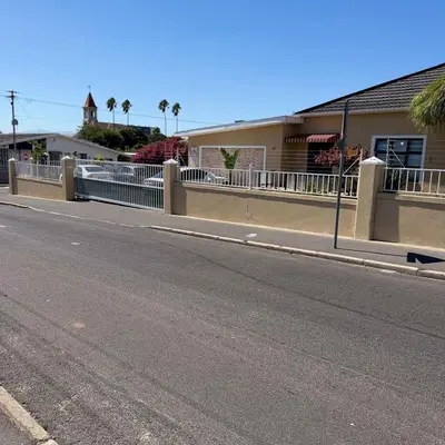 an empty street with a fence on the side of a road at Home of peace self catering accommodation