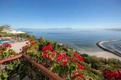 a view of the ocean from the balcony of a resort at Celtic Manor Boutique Guest House in Gordonʼs Bay