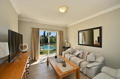 a living room with a couch and a tv at The lodge in Cape Town