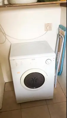 a white washer and dryer in a room at Pura Vida Hermanus in Hermanus