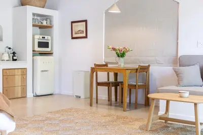 a living room with a table and a couch at The Oak Cottage in Wellington