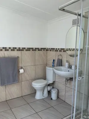 a bathroom with a toilet and a sink at Fijnbos Strand in Strand
