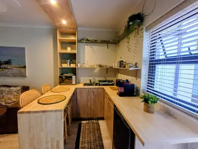 a kitchen with a large wooden counter and a window at GreenPeace in Stellenbosch