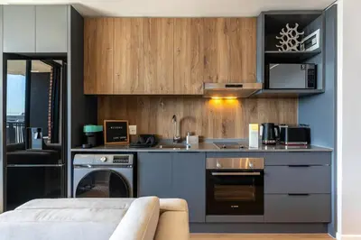 a kitchen with a sink and a stove at Stylish Executive Studio with Balcony in Riverlands, Observatory in Cape Town