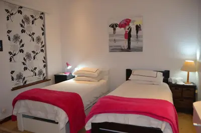 a bedroom with two beds with red and white sheets at Cape Dutch Family Home in the Winelands in Somerset West