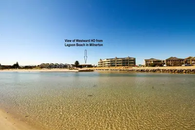 a view of a beach with buildings in the background at Westward HO Apartment 13 in Cape Town