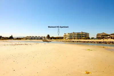 a view of a beach with a basketball hoop at Westward HO Apartment 13 in Cape Town