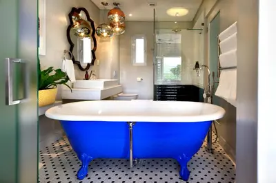 a large blue tub in a bathroom with a sink at Franschhoek Boutique Hotel - Lion Roars Hotels & Lodges in Franschhoek