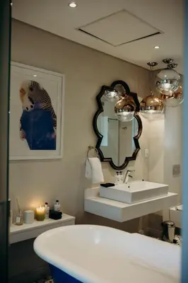 a bathroom with a white sink and a mirror at Franschhoek Boutique Hotel - Lion Roars Hotels & Lodges in Franschhoek
