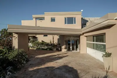 a large house with a driveway in front of it at Villa Marine Guest House in Pringle Bay
