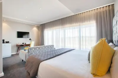 a bedroom with a bed and a large window at Bliss Boutique Hotel in Cape Town