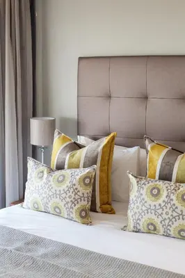 a bed with a bunch of pillows on it at Bliss Boutique Hotel in Cape Town