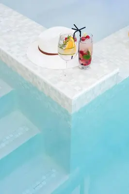 a table with a drink and a glass of fruit at Bliss Boutique Hotel in Cape Town
