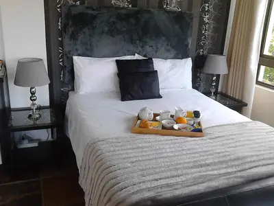 a tray of stuffed animals sitting on a bed at Port House in Bloubergstrand