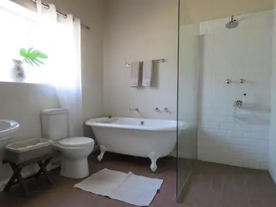 a bathroom with a tub and a toilet and a shower at Modderkloof Farm Accommodation in Paarl