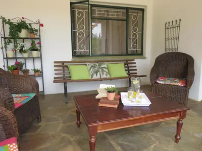 a living room with a table and chairs and a mirror at Modderkloof Farm Accommodation in Paarl