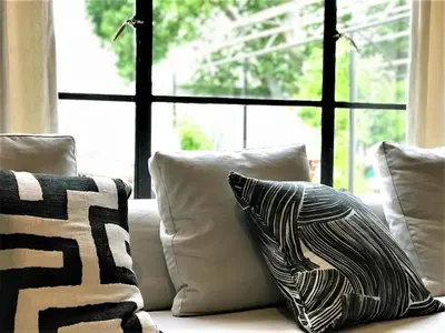a group of pillows sitting on a couch with a window at Beckhuis in Worcester