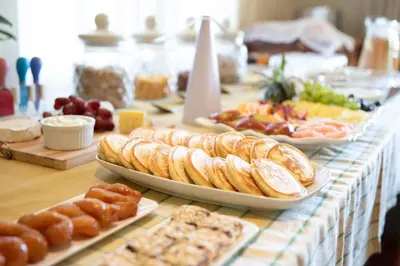 a table topped with different types of bread and pastries at Marshden Estate in Stellenbosch