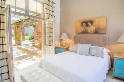 a bedroom with a bed and a sliding glass door at Marshden Estate in Stellenbosch