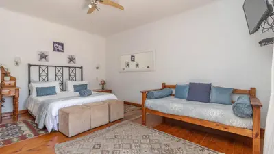a living room with two beds and a couch at House on Westcliff in Hermanus