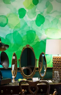 a dressing table with a mirror and a green wall at Akademie Street Boutique Hotel in Franschhoek