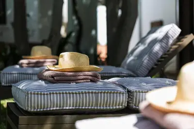 a stack of mattresses with a cowboy hat on top at Akademie Street Boutique Hotel in Franschhoek