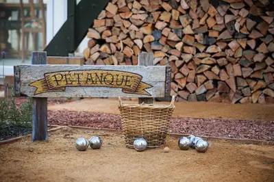 a wooden bench with a basket and balls under it at Akademie Street Boutique Hotel in Franschhoek