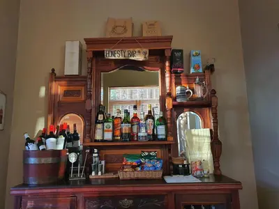 a bar with a mirror and bottles on it at Wild Olive Guest House & Villa in Cape Town