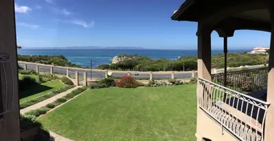 a balcony of a house with a view of the ocean at On The Cliff Guest House in Hermanus